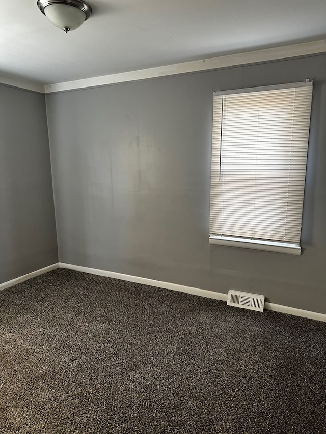 spare room featuring baseboards and visible vents