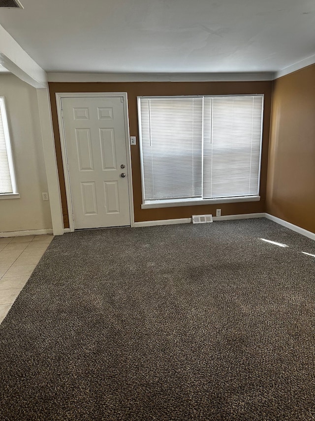 spare room featuring visible vents and baseboards