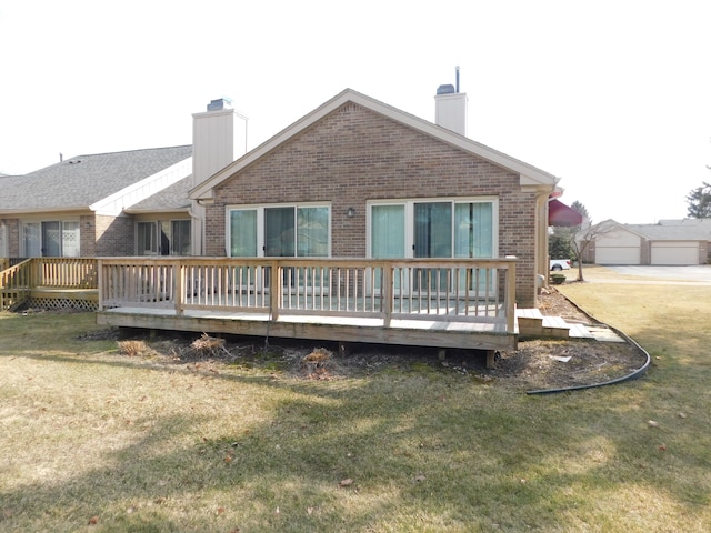 back of house featuring brick siding, a lawn, and a chimney