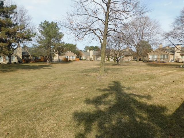 view of yard with a deck and a residential view