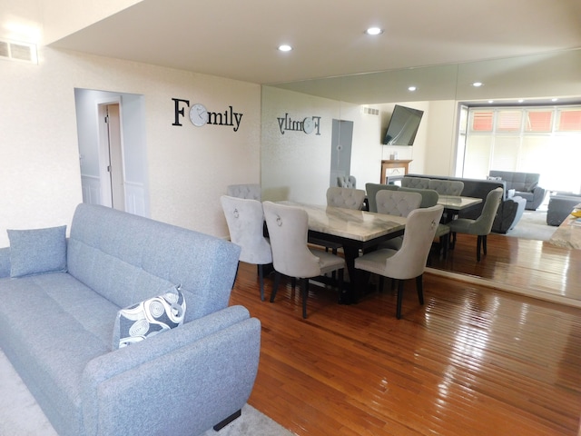 dining room featuring hardwood / wood-style flooring, recessed lighting, and visible vents