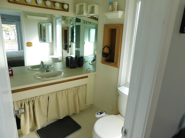 bathroom featuring toilet and vanity