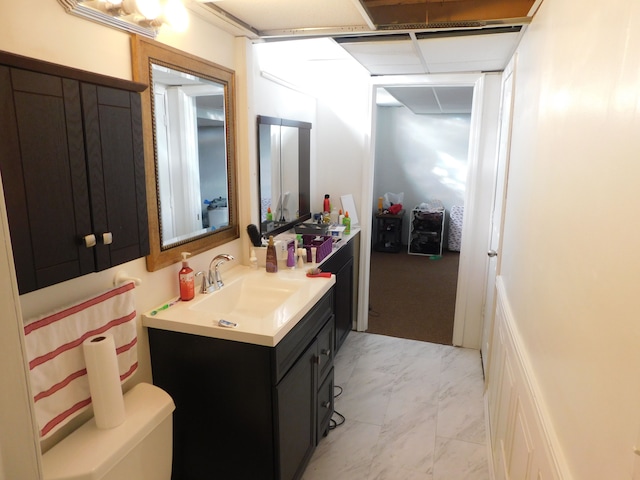 bathroom with vanity and marble finish floor