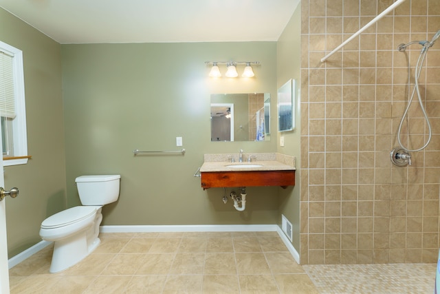 full bathroom featuring tile patterned floors, visible vents, toilet, and a tile shower