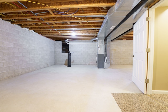 unfinished basement featuring heating unit