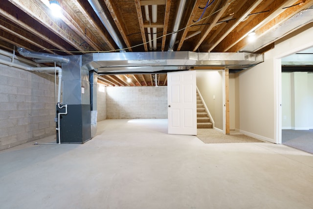 below grade area with stairway and heating unit