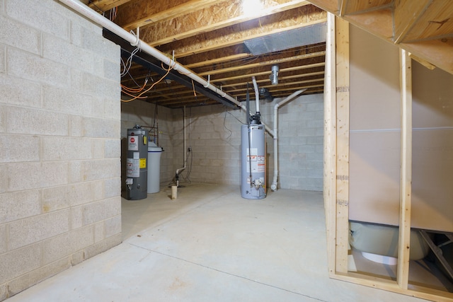 unfinished basement featuring gas water heater and water heater