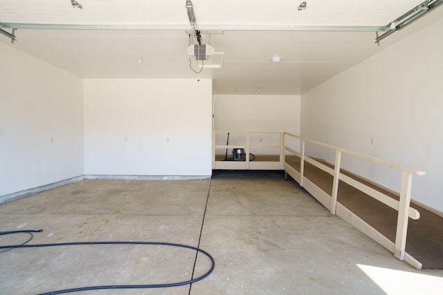 garage featuring baseboards and a garage door opener