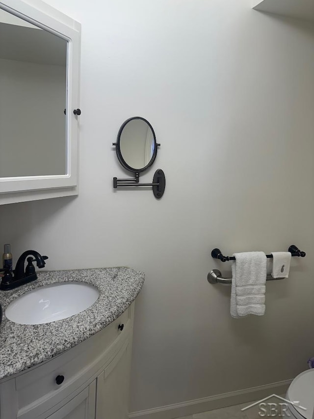 bathroom with vanity and baseboards