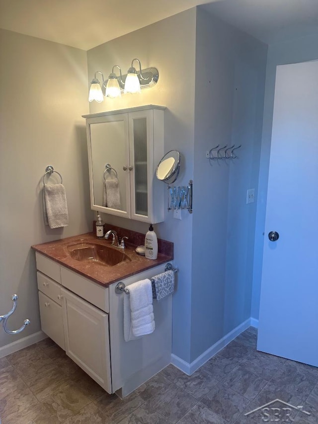 bathroom featuring vanity and baseboards