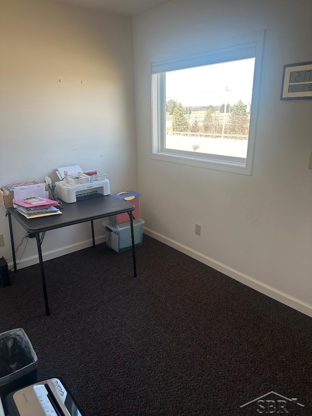 carpeted home office featuring baseboards