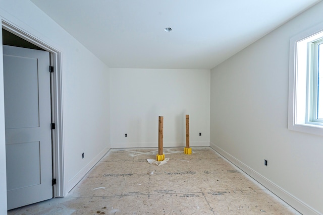 spare room with baseboards