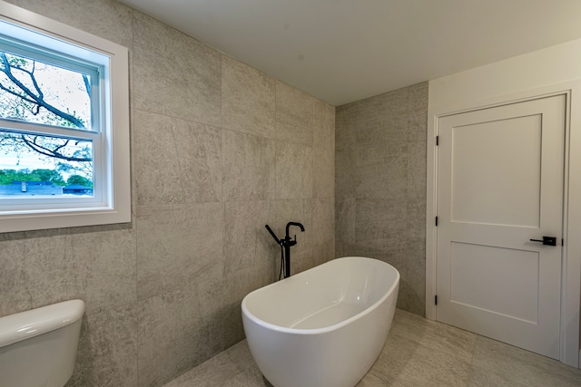 4107 Devon, Royal Oak, MI 48073 - bathroom with a freestanding tub, toilet, tile walls, and tile patterned flooring