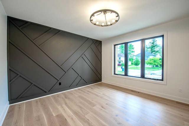 4107 Devon, Royal Oak, MI 48073 - unfurnished room with baseboards, a chandelier, and light wood-style floors