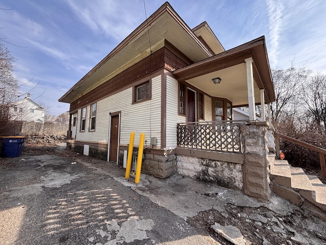 view of side of home with covered porch