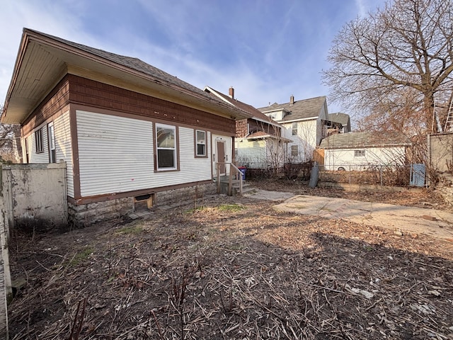 rear view of house featuring fence