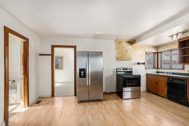 kitchen with dark countertops, visible vents, light wood-type flooring, appliances with stainless steel finishes, and open shelves