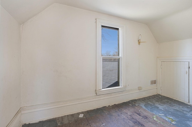 bonus room with visible vents, wood-type flooring, and vaulted ceiling