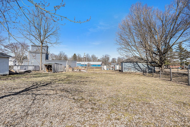 view of yard with an outdoor structure and fence