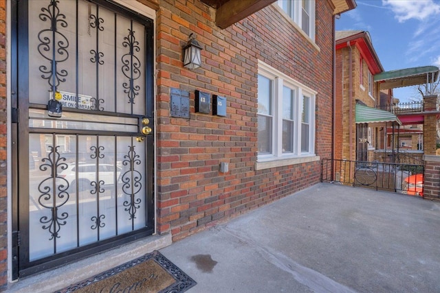 property entrance featuring brick siding