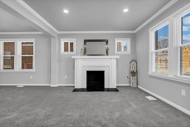 unfurnished living room with a brick fireplace, crown molding, baseboards, and carpet floors