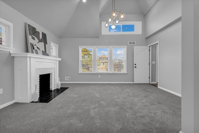 unfurnished living room featuring visible vents, a brick fireplace, a chandelier, and carpet flooring