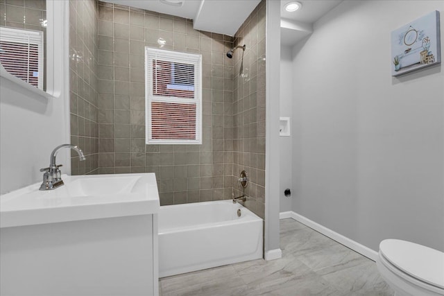 full bath featuring toilet, marble finish floor, baseboards, bathtub / shower combination, and vanity