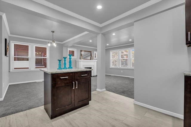 kitchen with dark brown cabinets, light colored carpet, baseboards, and ornamental molding