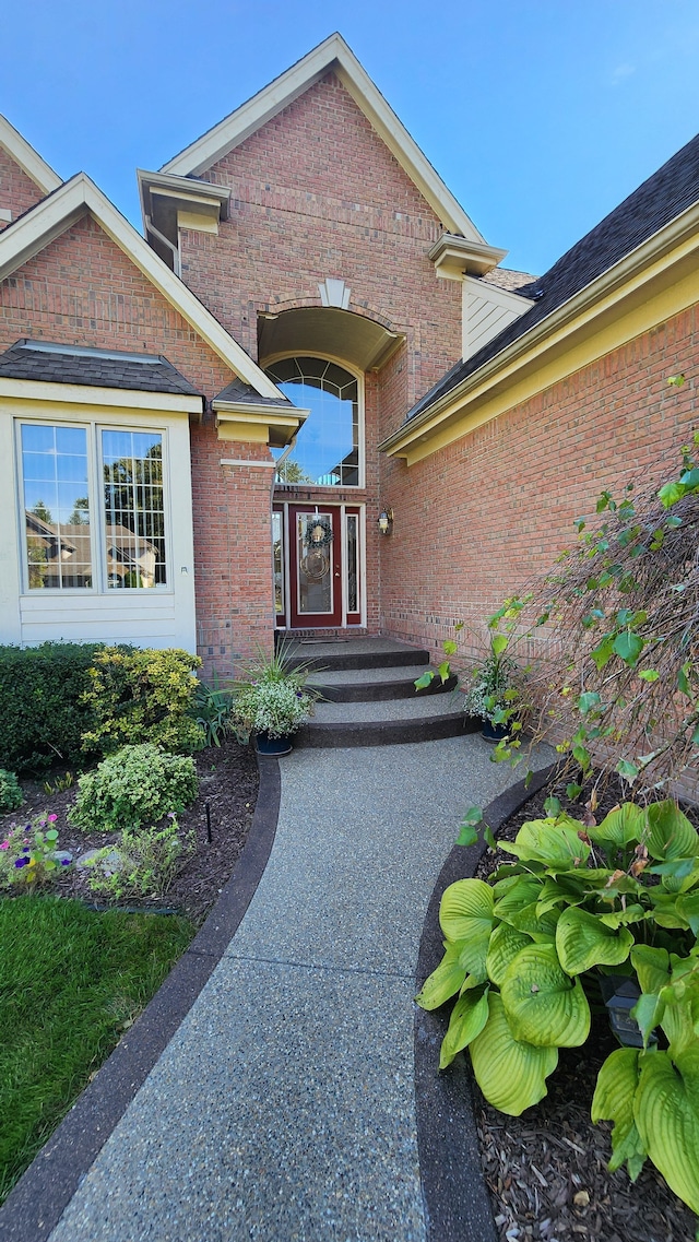 doorway to property featuring brick siding