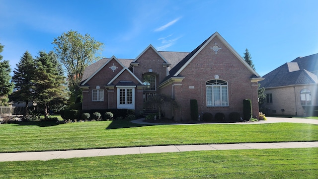 view of front of property featuring brick siding and a front yard