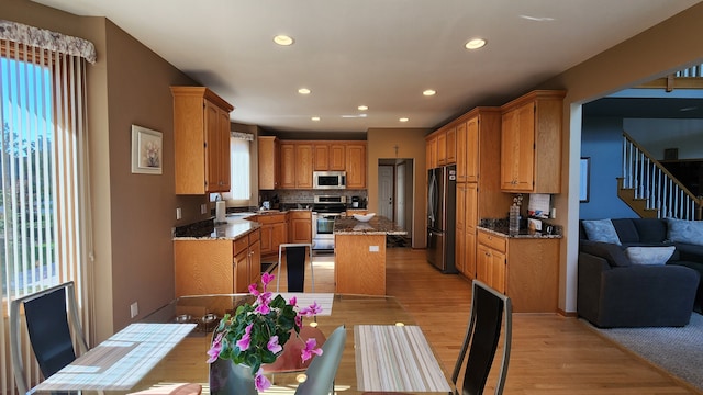 kitchen with a wealth of natural light, stainless steel appliances, and a kitchen island