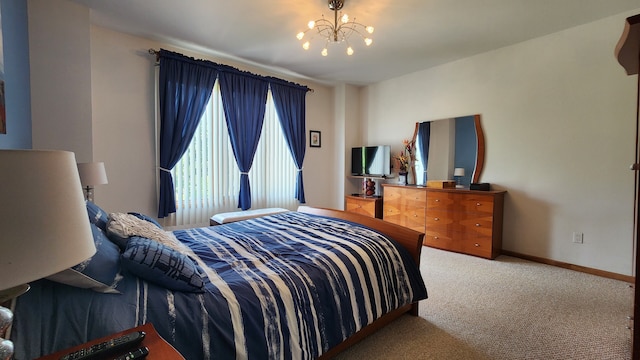 bedroom with a notable chandelier, carpet flooring, and baseboards