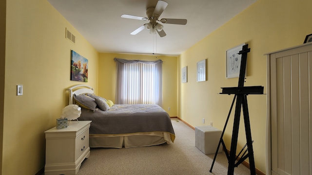 bedroom featuring ceiling fan, baseboards, visible vents, and light carpet