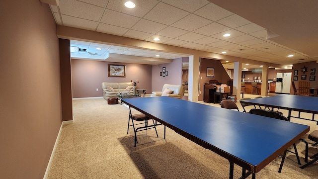 recreation room with recessed lighting, a drop ceiling, baseboards, and carpet