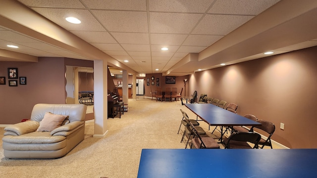 recreation room featuring recessed lighting, light colored carpet, baseboards, and a drop ceiling