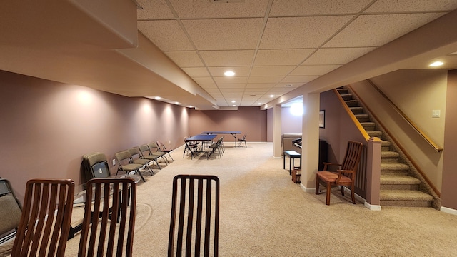 recreation room with recessed lighting, a paneled ceiling, baseboards, and carpet