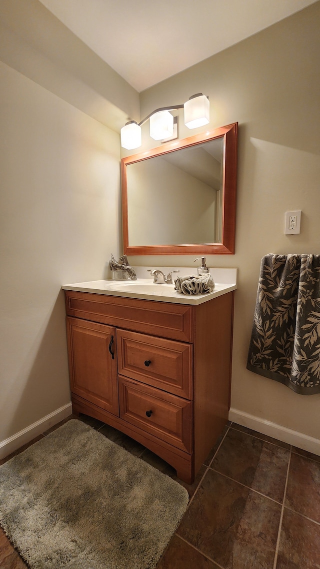 bathroom featuring vanity, baseboards, and tile patterned flooring