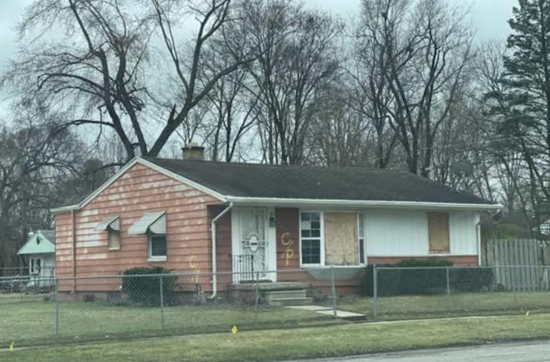 view of front of house featuring a front lawn, a fenced front yard, and a chimney