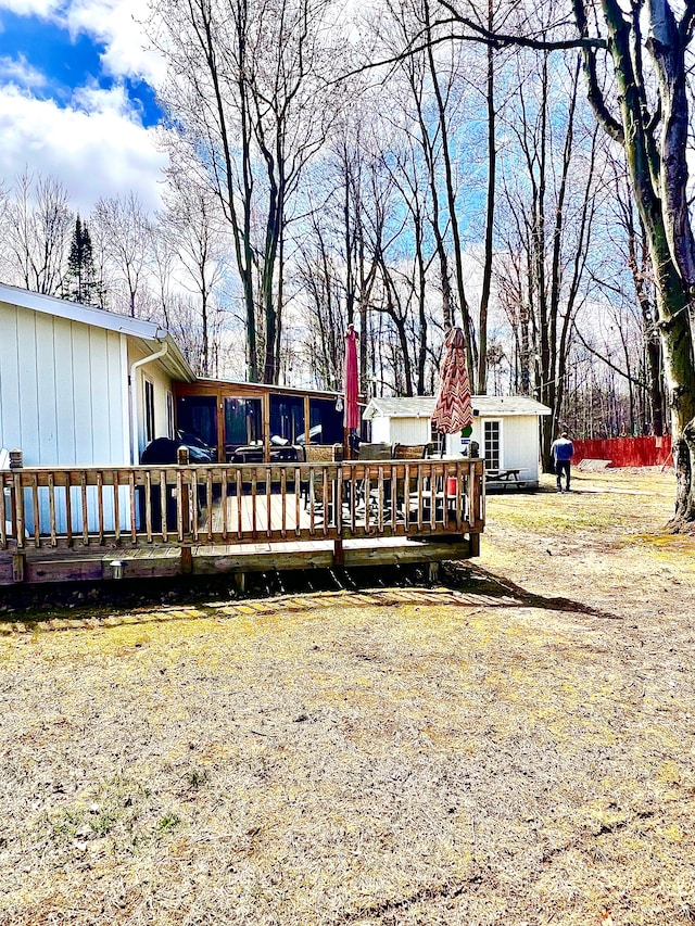 rear view of property featuring a wooden deck