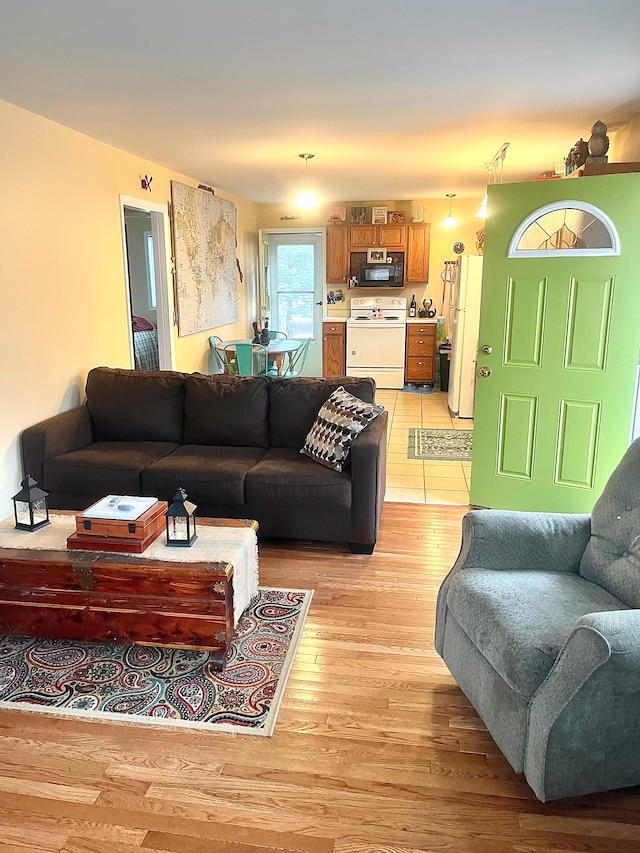 living room with washer / dryer and light wood-style floors