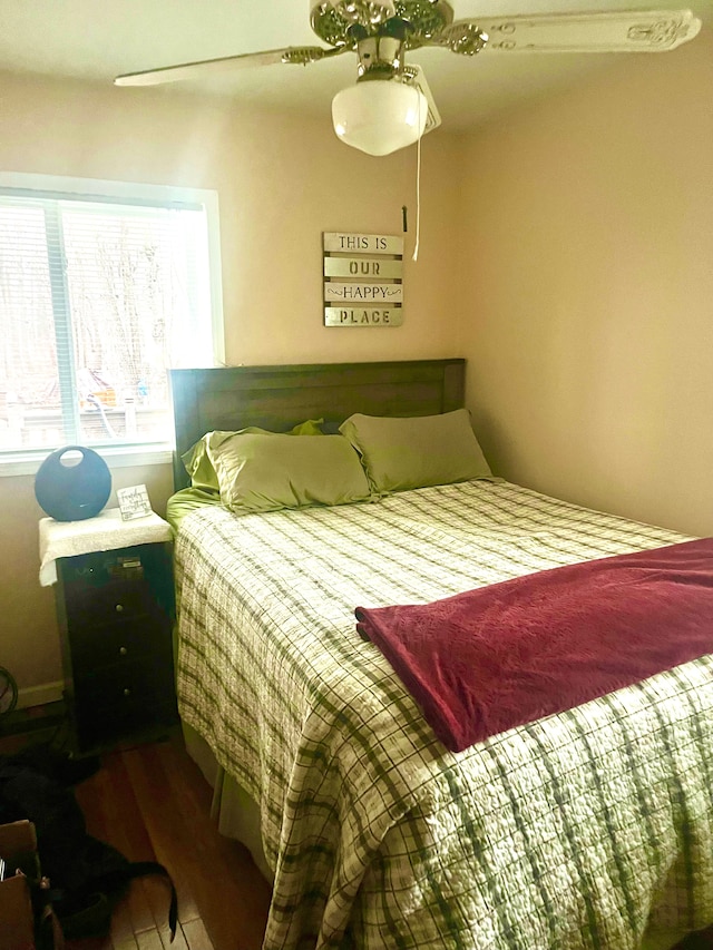 bedroom featuring wood finished floors and ceiling fan