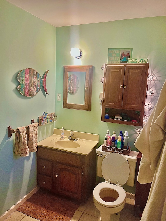 half bath featuring vanity, toilet, and baseboards