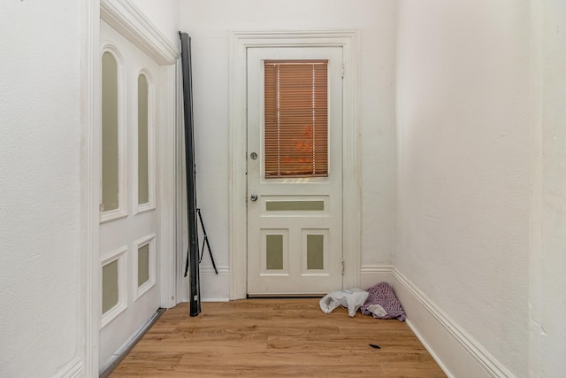 doorway to outside with light wood-style flooring