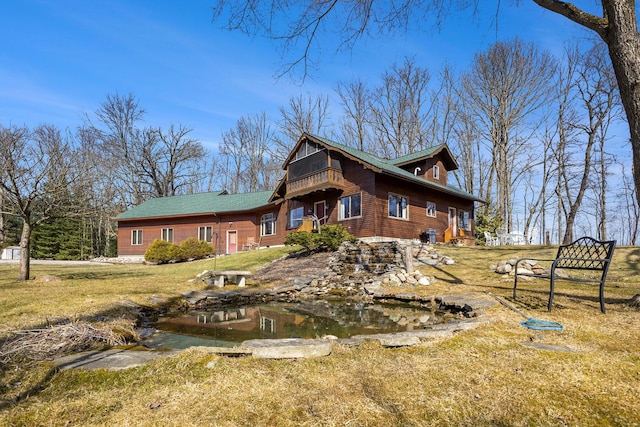 rear view of property with a lawn