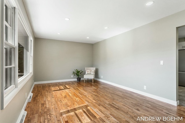 empty room featuring visible vents, recessed lighting, wood finished floors, and baseboards