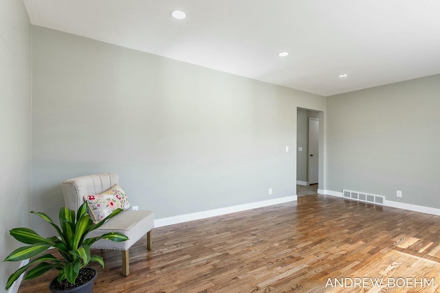 interior space featuring recessed lighting, wood finished floors, visible vents, and baseboards