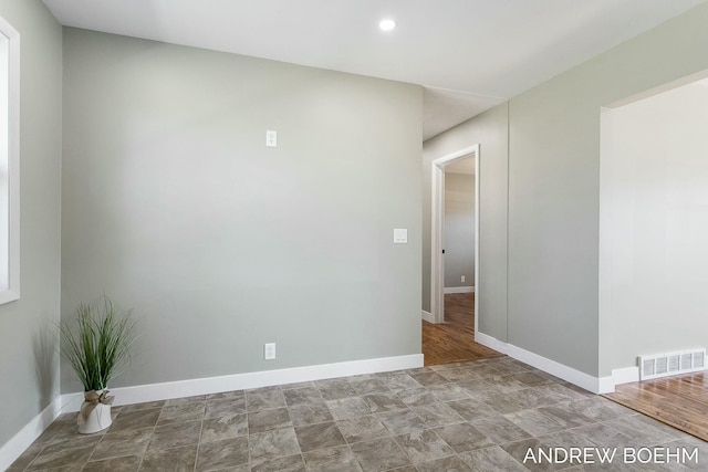 empty room with recessed lighting, baseboards, and visible vents