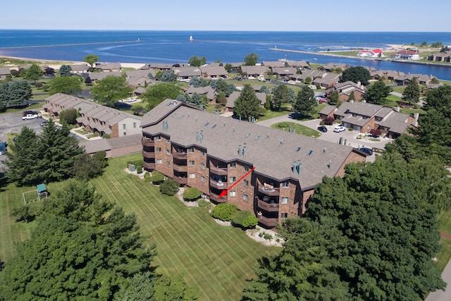 drone / aerial view featuring a water view and a residential view