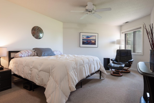 bedroom with visible vents, baseboards, carpet, and a ceiling fan