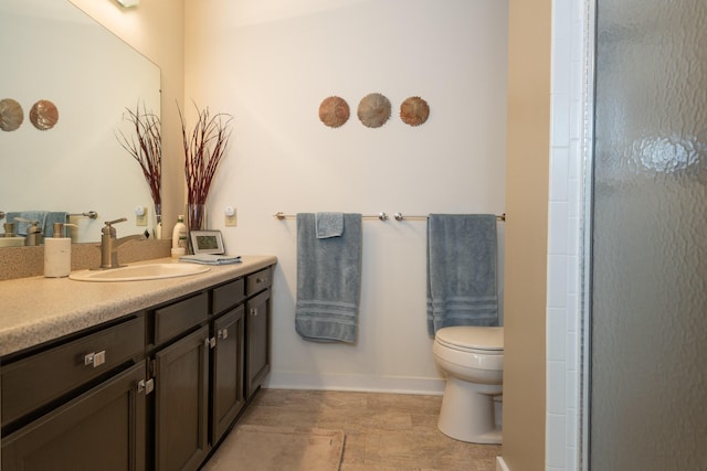 full bath featuring baseboards, toilet, and vanity